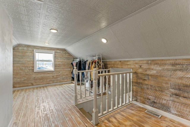 561 E Forest Ave, Colville, WA 99114 - additional living space featuring wood-type flooring, vaulted ceiling, and wooden walls