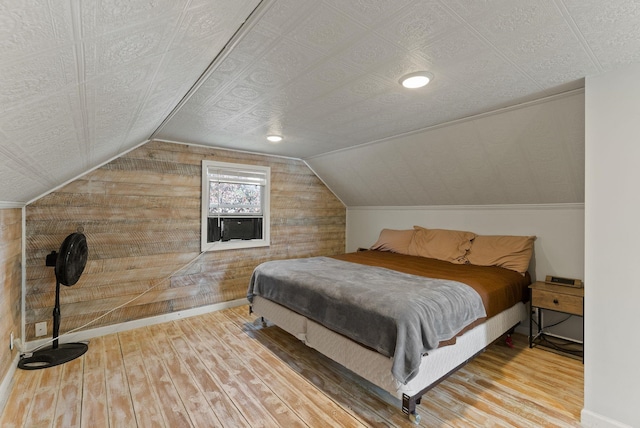561 E Forest Ave, Colville, WA 99114 - bedroom featuring hardwood / wood-style floors, wood walls, and lofted ceiling