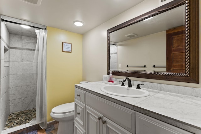561 E Forest Ave, Colville, WA 99114 - bathroom featuring vanity, tiled shower, and stone finish flooring
