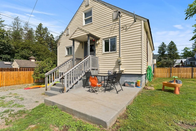 561 E Forest Ave, Colville, WA 99114 - back of property with a fenced backyard and a patio area