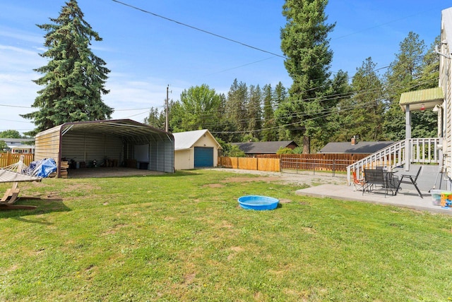 561 E Forest Ave, Colville, WA 99114 - view of yard with a detached carport and a detached garage