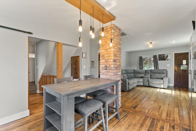 561 E Forest Ave, Colville, WA 99114 - dining room featuring wood-type flooring and decorative columns