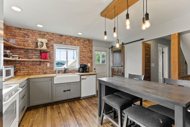 561 E Forest Ave, Colville, WA 99114 - kitchen featuring white appliances, gray cabinets, butcher block counters, a barn door, and open shelves