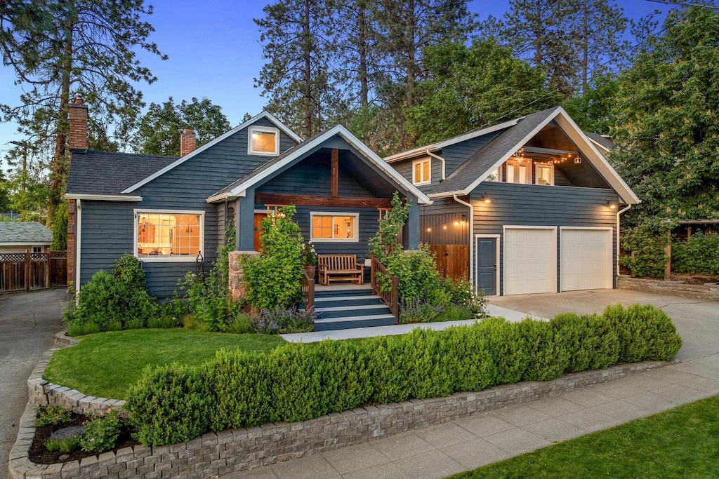 1635 S Maple Blvd, Spokane, WA 99203 - view of front facade featuring concrete driveway, a chimney, and a garage