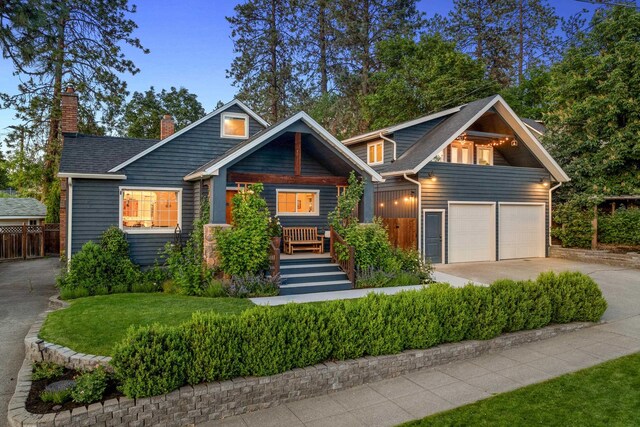 1635 S Maple Blvd, Spokane, WA 99203 - view of front facade featuring concrete driveway, a chimney, and a garage