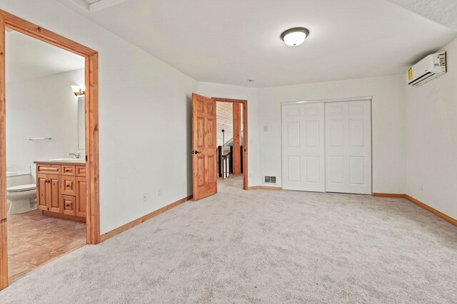 5011B Mason Rd, Clayton, WA 99110 - unfurnished bedroom with an AC wall unit, light colored carpet, a closet, and ensuite bathroom