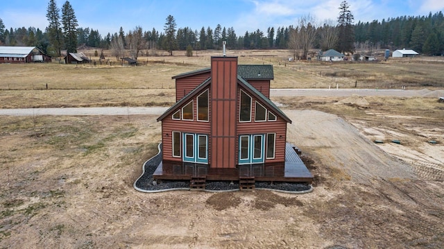 5011B Mason Rd, Clayton, WA 99110 - exterior view of faux log siding, a chimney, and a view of countryside