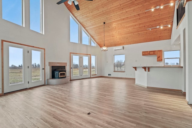 5011B Mason Rd, Clayton, WA 99110 - unfurnished living room with high vaulted ceiling, ceiling fan, a wall mounted AC, wooden ceiling, and light wood-type flooring