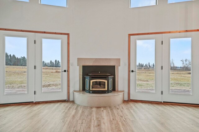 5011B Mason Rd, Clayton, WA 99110 - unfurnished living room with wood finished floors, plenty of natural light, a towering ceiling, and a wood stove