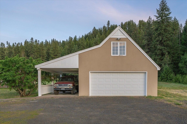 4408 E Spangle Creek Rd, Valleyford, WA 99036 - garage featuring a detached garage and a wooded view
