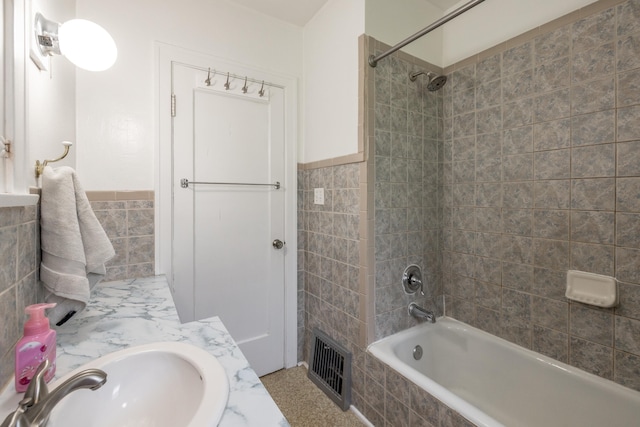 530 W Gordon Ave Unit 013, Spokane, WA 99205 - bathroom with tile walls, tiled shower / bath, vanity, and wainscoting