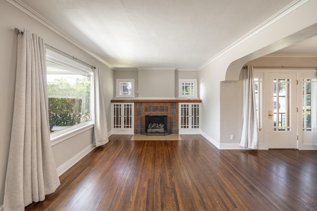 530 W Gordon Ave Unit 013, Spokane, WA 99205 - unfurnished living room with wood finished floors, crown molding, a brick fireplace, and arched walkways