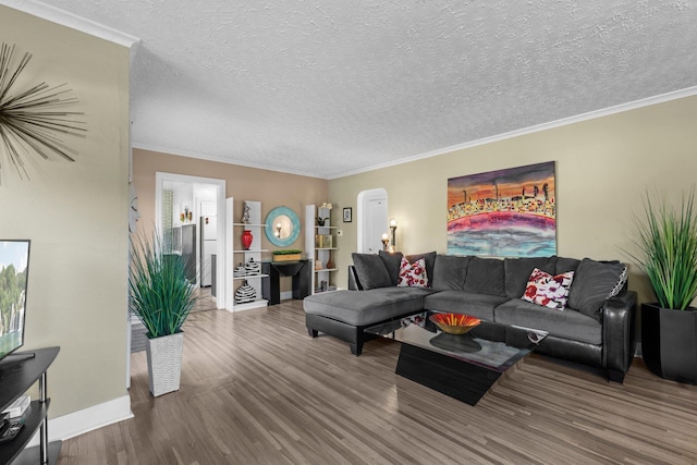 824 E E 38th Ave, Spokane, WA 99203 - living room featuring wood finished floors, a textured ceiling, ornamental molding, and arched walkways