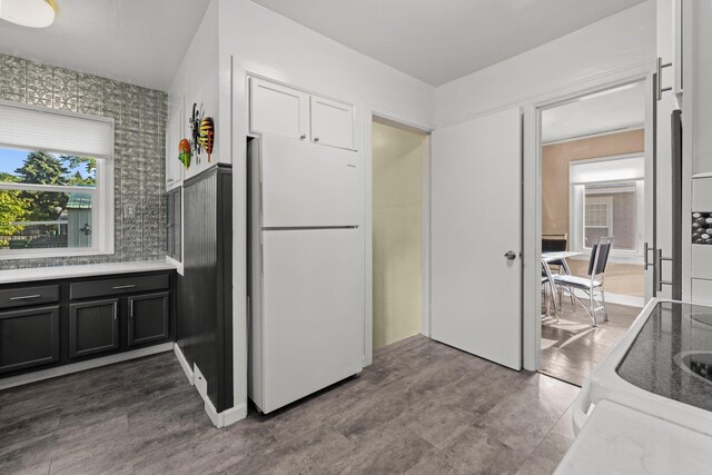 824 E E 38th Ave, Spokane, WA 99203 - kitchen with freestanding refrigerator, dark cabinetry, and range