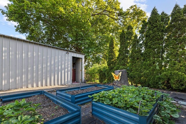824 E E 38th Ave, Spokane, WA 99203 - wooden deck with a vegetable garden and an outbuilding