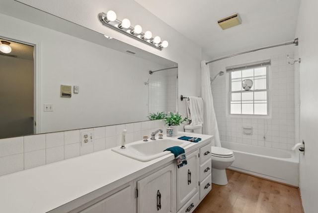 11628 N Galahad Dr, Spokane, WA 99218 - full bath featuring vanity, shower / tub combo with curtain, wood finished floors, and tasteful backsplash