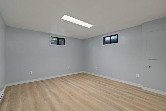 11628 N Galahad Dr, Spokane, WA 99218 - basement with light wood-type flooring and a baseboard radiator