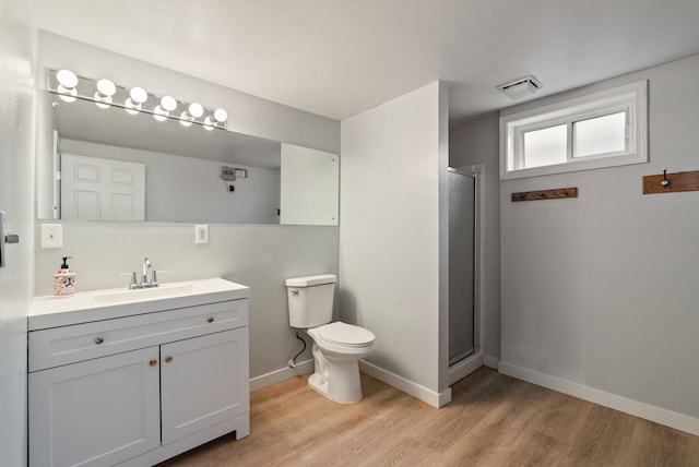 11628 N Galahad Dr, Spokane, WA 99218 - bathroom featuring wood finished floors, vanity, and an enclosed shower
