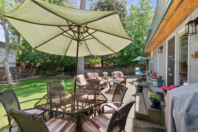 11628 N Galahad Dr, Spokane, WA 99218 - fenced backyard featuring outdoor dining area, a patio, and an outdoor hangout area