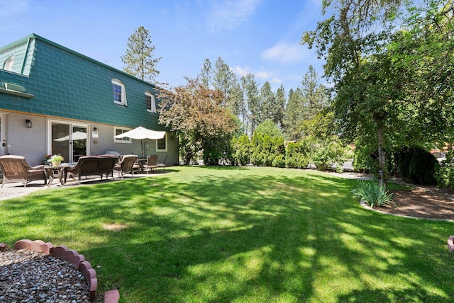 11628 N Galahad Dr, Spokane, WA 99218 - view of green lawn featuring a patio area
