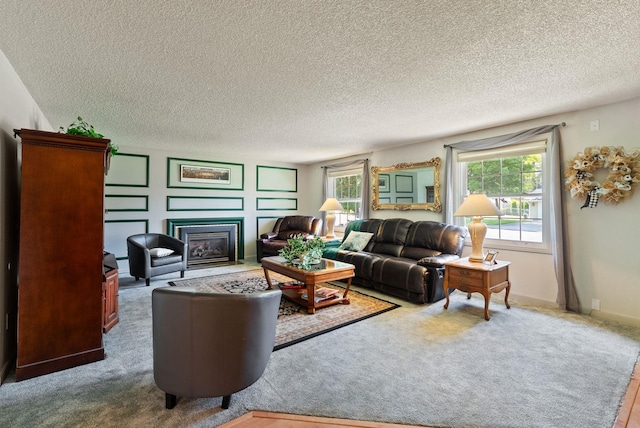 11628 N Galahad Dr, Spokane, WA 99218 - living room with plenty of natural light, a fireplace with flush hearth, a textured ceiling, and carpet flooring