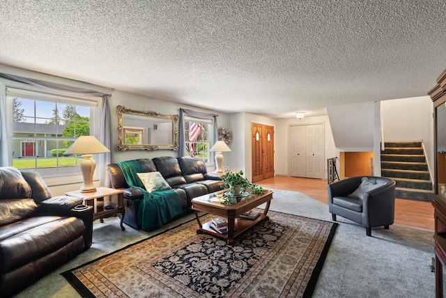 11628 N Galahad Dr, Spokane, WA 99218 - living room featuring plenty of natural light, stairway, light carpet, and a textured ceiling