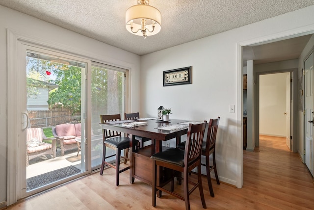 11628 N Galahad Dr, Spokane, WA 99218 - dining space featuring a textured ceiling and light wood-type flooring