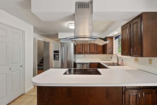 11628 N Galahad Dr, Spokane, WA 99218 - kitchen featuring appliances with stainless steel finishes, island exhaust hood, light countertops, a peninsula, and dark brown cabinets