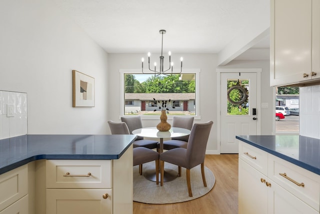 2917 W Dalton Ave, Spokane, WA 99205 - dining area featuring light wood finished floors, a chandelier, and healthy amount of natural light
