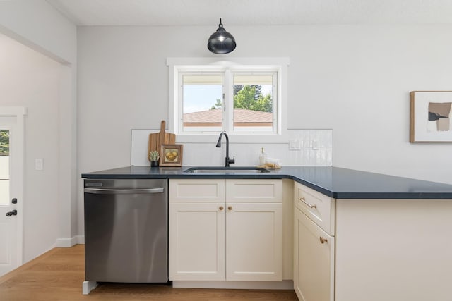 2917 W Dalton Ave, Spokane, WA 99205 - kitchen featuring dishwasher, dark countertops, tasteful backsplash, and light wood-style flooring