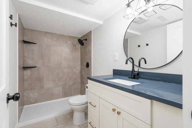 2917 W Dalton Ave, Spokane, WA 99205 - bathroom featuring vanity, tile patterned flooring, a tile shower, and a textured ceiling