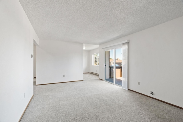 107 E Hattie Ave, Coeur D Alene, ID 83814 - spare room featuring light colored carpet, a textured ceiling, and baseboard heating