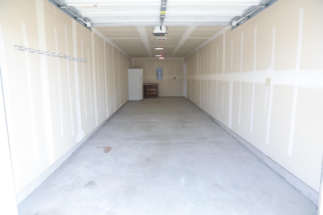 315 E I St, Deer Park, WA 99006 - garage with a garage door opener, electric panel, and freestanding refrigerator