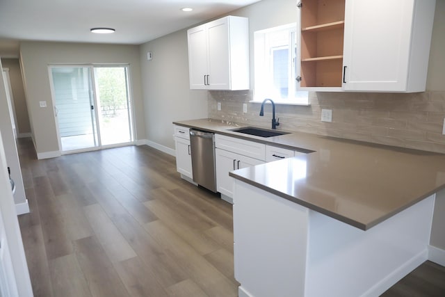 315 E I St, Deer Park, WA 99006 - kitchen featuring dishwasher, white cabinetry, backsplash, a peninsula, and light wood-style floors