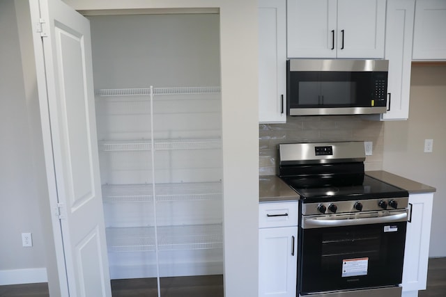 315 E I St, Deer Park, WA 99006 - kitchen featuring appliances with stainless steel finishes, tasteful backsplash, and white cabinetry