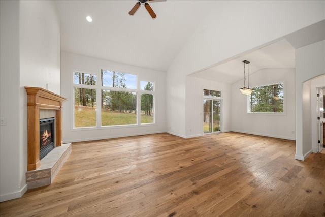 404 W Trail Ridge Ct, Spokane, WA 99224 - unfurnished living room with a tile fireplace, plenty of natural light, ceiling fan, light wood-style flooring, and high vaulted ceiling