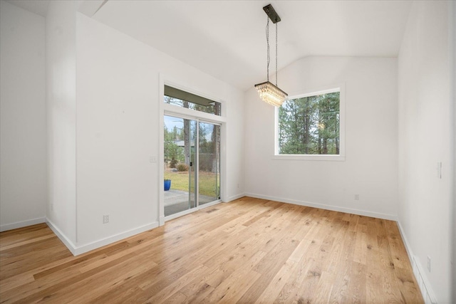 404 W Trail Ridge Ct, Spokane, WA 99224 - empty room with light wood-style floors, vaulted ceiling, and a chandelier