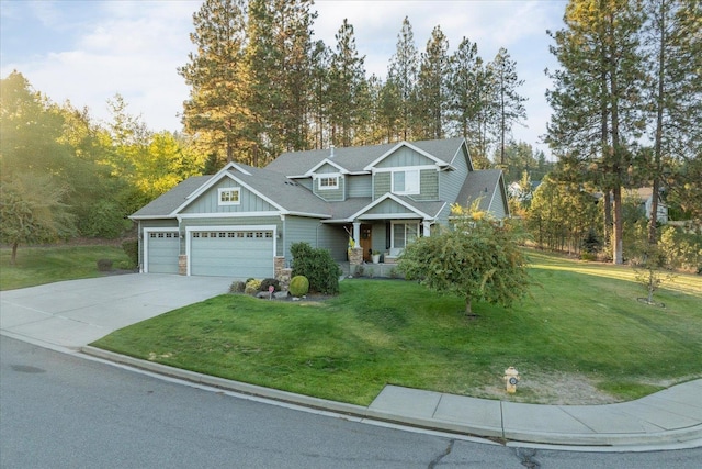 404 W Trail Ridge Ct, Spokane, WA 99224 - view of front of house with board and batten siding, a garage, a front yard, concrete driveway, and stone siding