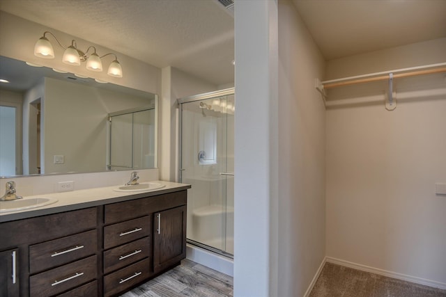 8115 W 57th Ave, Spokane, WA 99224 - full bathroom featuring a stall shower, double vanity, and a walk in closet