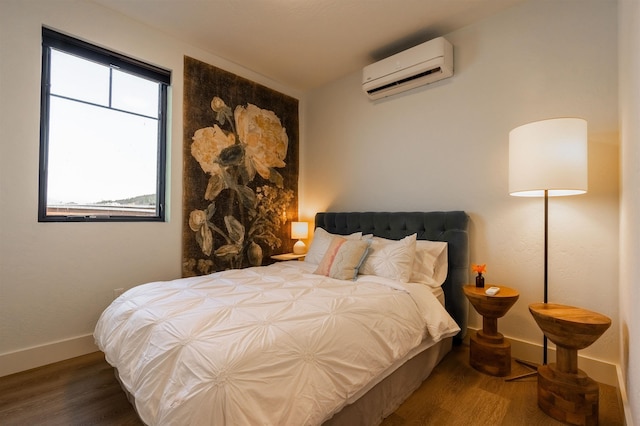 115 E Lake St Unit 203, Sandpoint, ID 83864 - bedroom featuring an AC wall unit and wood finished floors