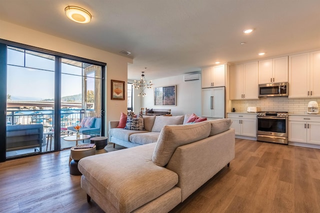 115 E Lake St Unit 203, Sandpoint, ID 83864 - living room featuring a wall mounted AC, a chandelier, light wood-type flooring, and recessed lighting