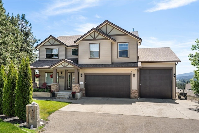 7620 E Ruby Ln, Spokane, WA 99212 - view of front of property with driveway, roof with shingles, a porch, and an attached garage