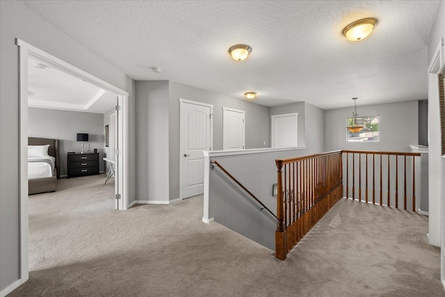 7620 E Ruby Ln, Spokane, WA 99212 - corridor with an upstairs landing, carpet flooring, and a textured ceiling