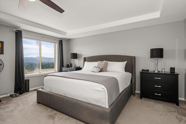 7620 E Ruby Ln, Spokane, WA 99212 - bedroom with light colored carpet, a tray ceiling, and ceiling fan