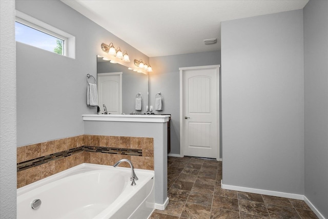 7620 E Ruby Ln, Spokane, WA 99212 - full bathroom featuring a garden tub, vanity, and stone finish floors