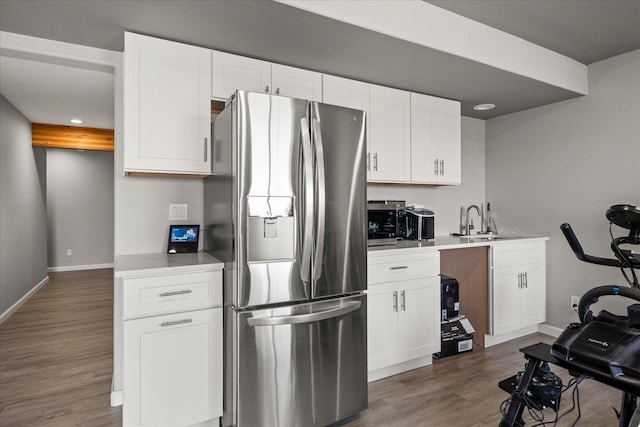 7620 E Ruby Ln, Spokane, WA 99212 - kitchen featuring stainless steel refrigerator with ice dispenser, wood finished floors, light countertops, white cabinetry, and recessed lighting