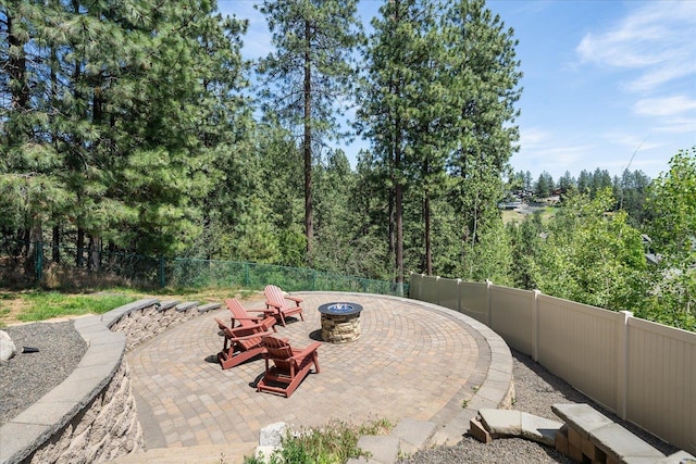 7620 E Ruby Ln, Spokane, WA 99212 - fenced backyard featuring an outdoor fire pit and a patio area