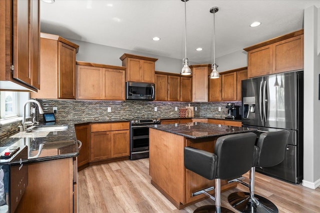 7620 E Ruby Ln, Spokane, WA 99212 - kitchen with appliances with stainless steel finishes, brown cabinets, light wood finished floors, and recessed lighting