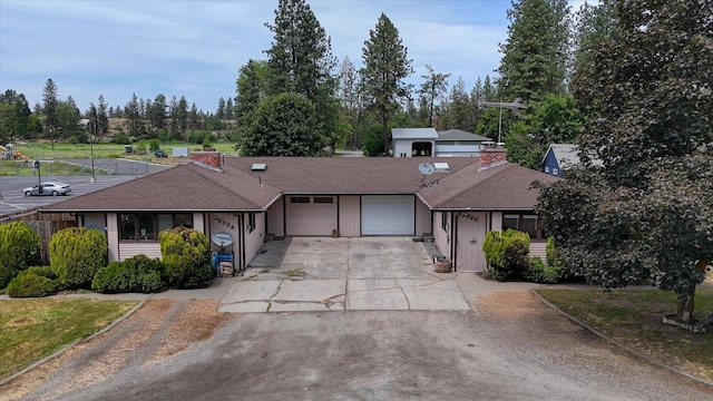 5022 W Garden Springs Ave Unit 5024W, Garden Springs, Spokane, WA 99224 - ranch-style house featuring a garage, concrete driveway, roof with shingles, and view of scattered trees