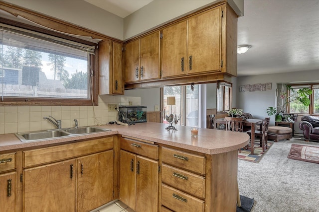 5022 W Garden Springs Ave Unit 5024W, Garden Springs, Spokane, WA 99224 - kitchen with a peninsula, light countertops, brown cabinetry, open floor plan, and backsplash